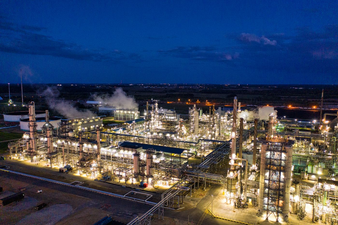 Oil refinery lit up against the night sky