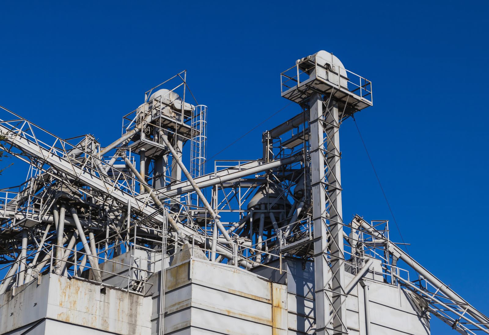 Industrial plant structures against a clear sky
