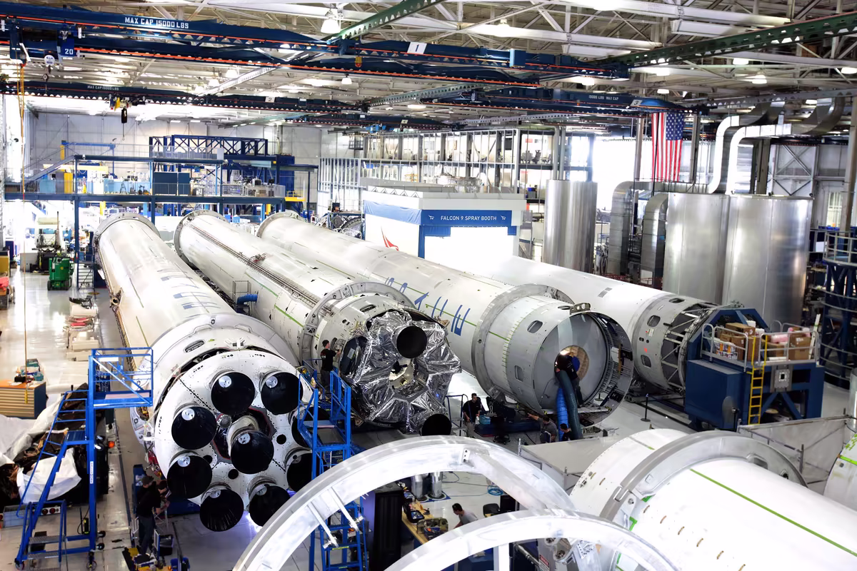 Spacecraft being assembled inside an industrial manufacturing facility