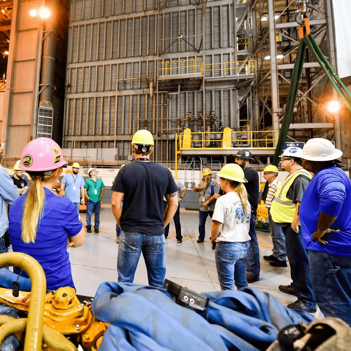 NASA workplace safety culture training session showing personnel engaged in safety briefing within an industrial space environment.