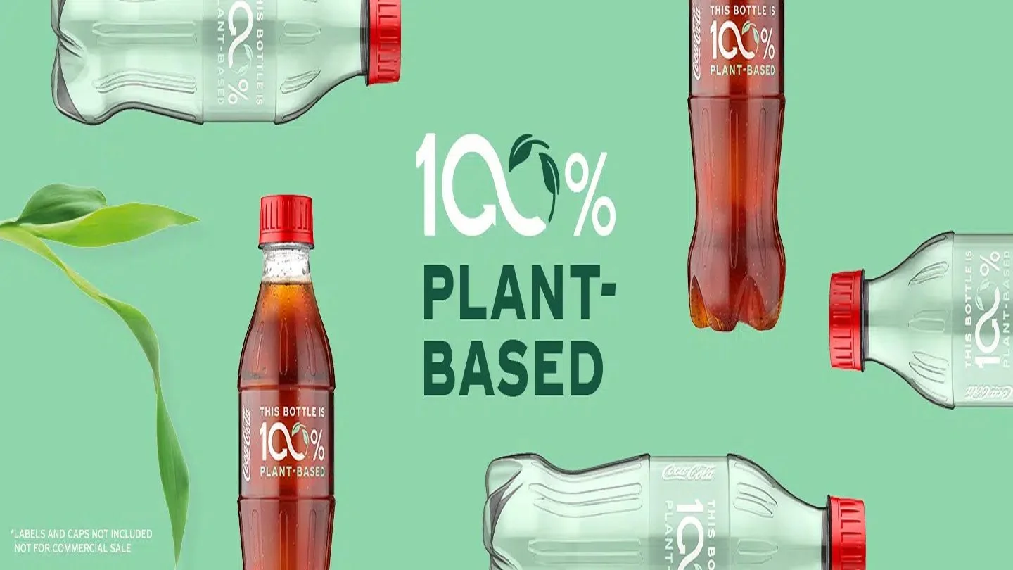 Coca-Cola bottles labeled "This bottle is 100% plant-based"