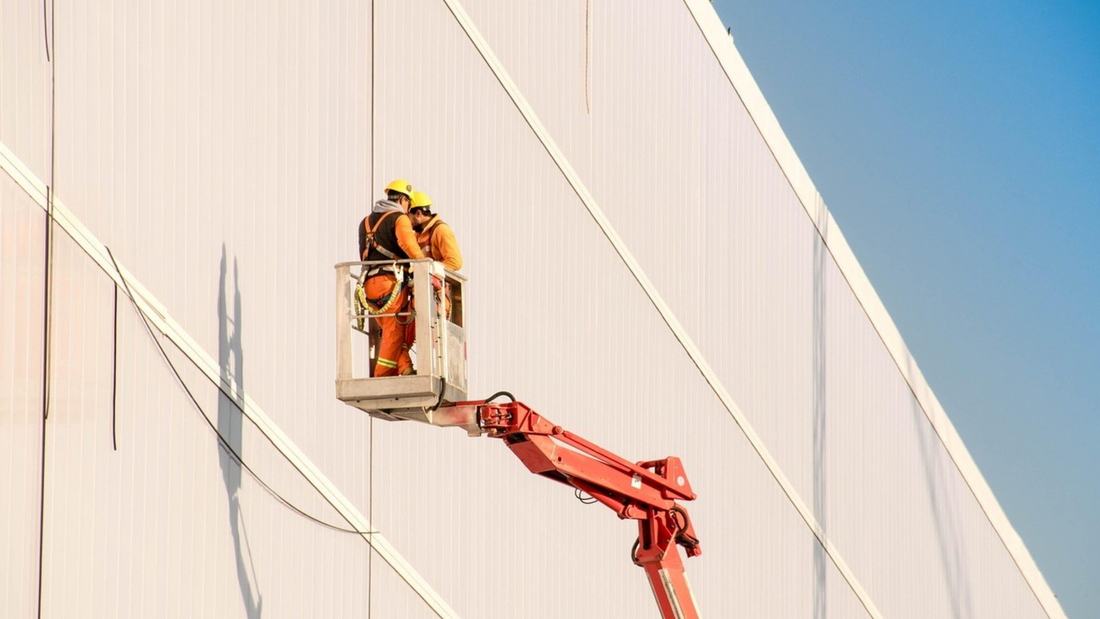 man in white hard hat standing on brown wooden dock during daytime