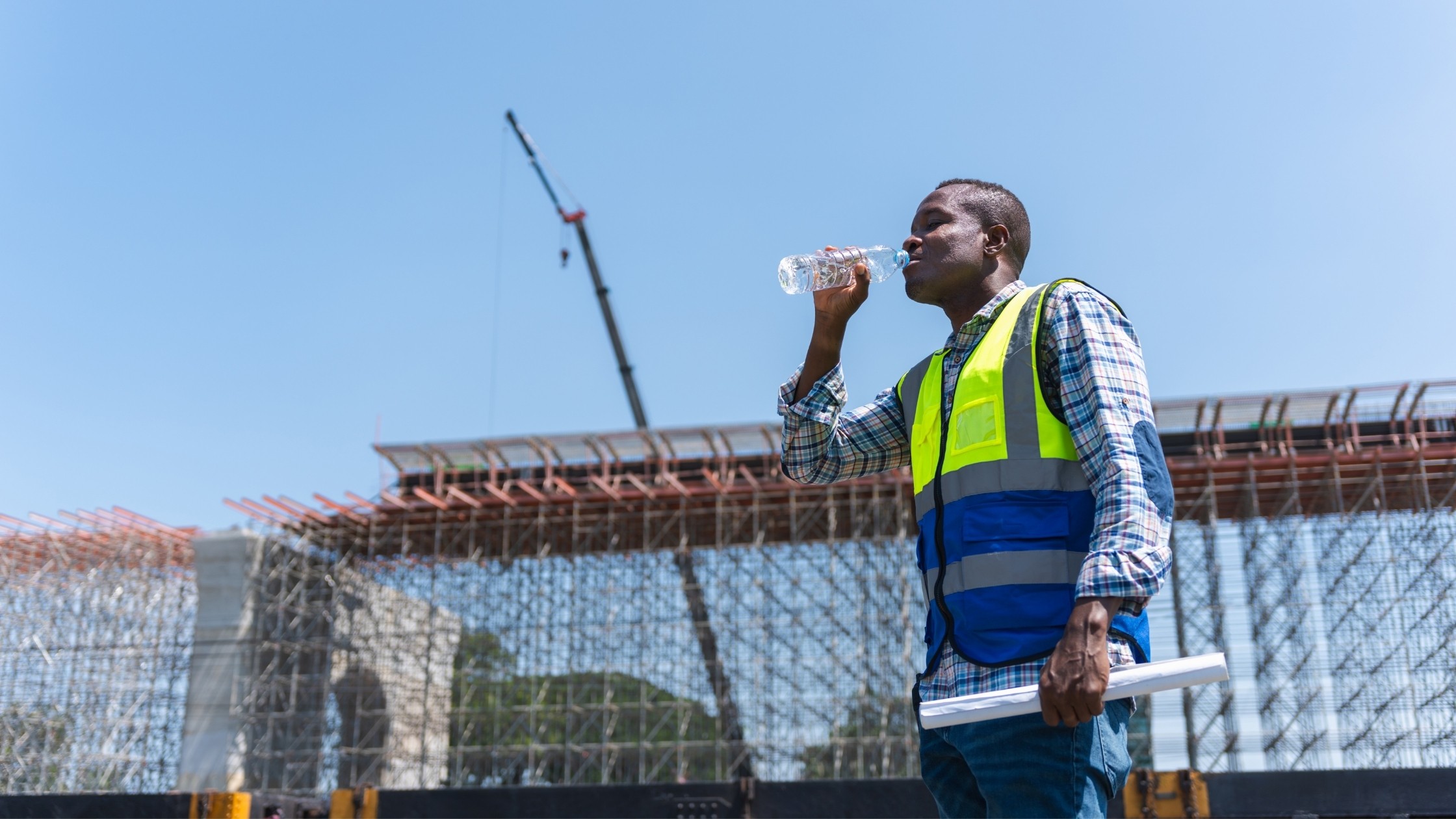 Construction worker drinking water