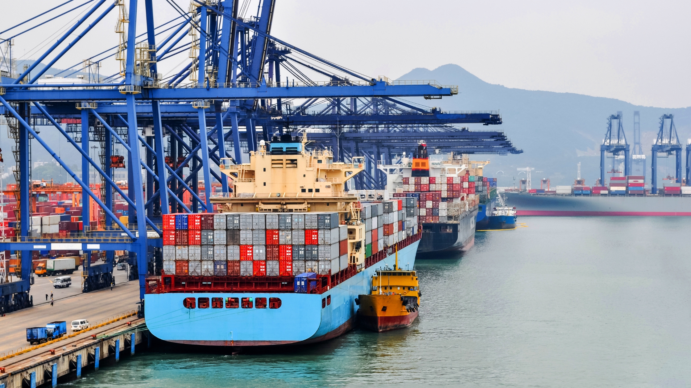 Container ship in port at container terminal Port Shenzhen, China. Ships of container ships stand in terminal of port on loading, unloading container